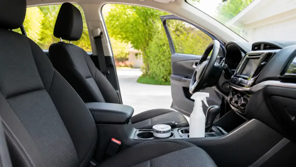 Car odor eliminator spray and deodorizing device on a clean center console