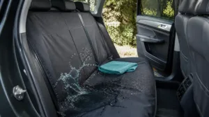 Water splashing on a fitted waterproof rear car seat cover