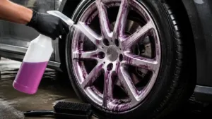 Wheel cleaner being sprayed onto brake dust on a silver alloy wheel